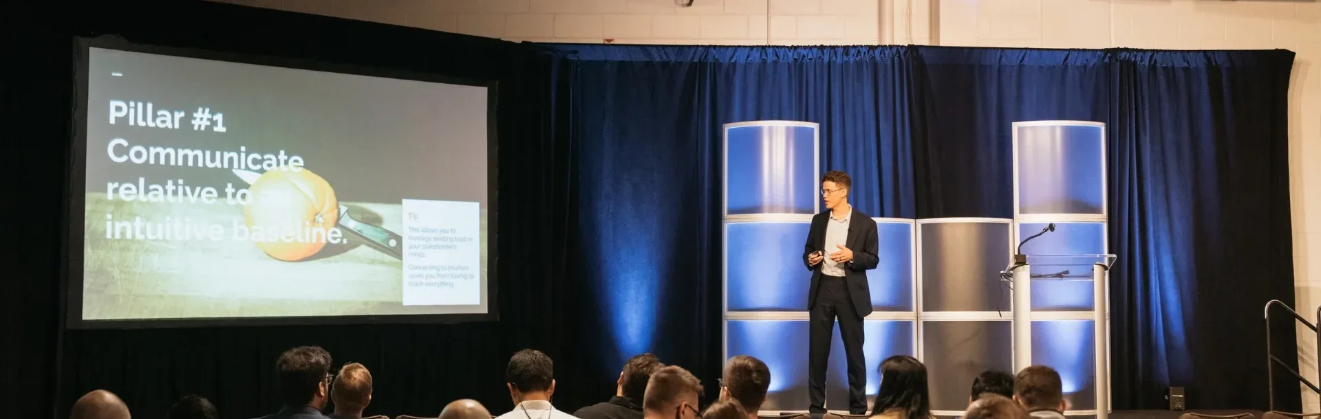 Speaker presenting on the main stage at MLOps World